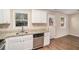 Updated kitchen with white cabinets, granite countertops, and stainless steel appliances at 3519 Adkins Nw Rd, Atlanta, GA 30331