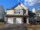 Two-story house with stone accents, two-car garage, and landscaping at 4480 Bradstone Nw Trce, Lilburn, GA 30047