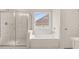 Bathroom with a walk-in shower and a soaking tub at 7174 Linden Dr, South Fulton, GA 30349