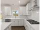 Modern kitchen with white cabinets, stainless steel appliances and gas cooktop at 7174 Linden Dr, South Fulton, GA 30349