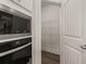 Bright kitchen pantry with wire shelving and modern flooring at 7174 Linden Dr, South Fulton, GA 30349
