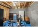 Unfinished basement with workout equipment and storage at 775 Holcombe Woods Ct, Auburn, GA 30011