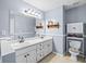 Double vanity bathroom with a toilet and linen cabinet at 775 Holcombe Woods Ct, Auburn, GA 30011