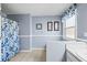 Clean bathroom with shower, tile floor, and window at 775 Holcombe Woods Ct, Auburn, GA 30011