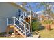 Rear deck with stairs leading to the backyard, offering outdoor access at 775 Holcombe Woods Ct, Auburn, GA 30011