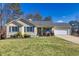 Ranch style home with landscaped lawn, attached garage, and neutral siding at 775 Holcombe Woods Ct, Auburn, GA 30011
