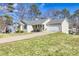 House exterior showcasing a large yard and driveway at 775 Holcombe Woods Ct, Auburn, GA 30011