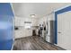 Modern kitchen with white cabinets, stainless steel appliances, and blue accent wall at 775 Holcombe Woods Ct, Auburn, GA 30011