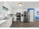 Modern kitchen with white cabinets and stainless steel appliances at 775 Holcombe Woods Ct, Auburn, GA 30011