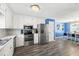 Updated kitchen with white cabinets, stainless steel appliances, and a view into the dining room at 775 Holcombe Woods Ct, Auburn, GA 30011