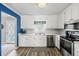 Clean and efficient kitchen featuring white cabinets and stainless steel appliances at 775 Holcombe Woods Ct, Auburn, GA 30011