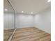 Finished basement room with hardwood floors and mirror wall at 2750 Olde Towne Pkwy, Duluth, GA 30097