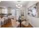 Dining area with hardwood floors, modern chandelier, and convenient access to the laundry room at 2750 Olde Towne Pkwy, Duluth, GA 30097