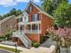 Brick two-story house with white trim, stairs, and landscaping at 2750 Olde Towne Pkwy, Duluth, GA 30097