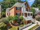 Brick two-story house with a front porch and a white picket fence at 2750 Olde Towne Pkwy, Duluth, GA 30097