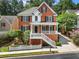 Brick two-story home with white trim and a front porch at 2750 Olde Towne Pkwy, Duluth, GA 30097