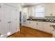 White kitchen with double oven, microwave, and ample storage at 2750 Olde Towne Pkwy, Duluth, GA 30097
