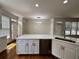 Modern open concept kitchen boasts stainless steel appliances, new cabinets, and eat-in bar at 2750 Olde Towne Pkwy, Duluth, GA 30097
