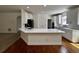 Modern kitchen with white cabinets, breakfast bar, hardwood floors, and stainless steel appliances at 2750 Olde Towne Pkwy, Duluth, GA 30097