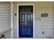 Dark blue front door accented with a welcome sign at 4660 Whispering Woods Dr, Cumming, GA 30040