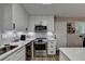 Modern kitchen with white cabinets, stainless steel appliances, and subway tile backsplash at 4660 Whispering Woods Dr, Cumming, GA 30040