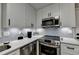 Modern kitchen with white cabinets and stainless steel appliances at 4660 Whispering Woods Dr, Cumming, GA 30040