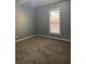 Spacious carpeted bedroom with a large window at 693 Dill Sw Ave, Atlanta, GA 30310