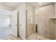 Bathroom featuring walk-in shower with clear glass doors and neutral tile at 2024 Avalon Rdg, Conyers, GA 30013