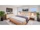 Staged bedroom with soft rug, wooden bed frame, plants, and natural light at 2024 Avalon Rdg, Conyers, GA 30013