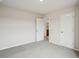 Bedroom with carpet, neutral walls and a view into a bathroom at 2024 Avalon Rdg, Conyers, GA 30013
