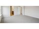 Spacious bedroom with neutral carpet, light grey walls, and a view into the attached bathroom at 2024 Avalon Rdg, Conyers, GA 30013