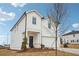 Beautiful two-story home with white siding, a front porch, and a two-car garage at 2024 Avalon Rdg, Conyers, GA 30013