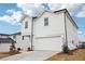 Charming two-story home featuring white siding, a two-car garage, and fresh landscaping at 2024 Avalon Rdg, Conyers, GA 30013