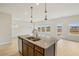 Kitchen island featuring a sink and granite countertop with view into the living room at 2024 Avalon Rdg, Conyers, GA 30013
