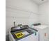 Laundry room with a modern washer and dryer and a wire shelf above at 2024 Avalon Rdg, Conyers, GA 30013