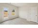 Bright living room features wood-look floors, a window, and a glass door to the outdoors at 2024 Avalon Rdg, Conyers, GA 30013