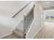 Elegant staircase with carpeted steps and a wooden handrail, leading to the upper level at 2024 Avalon Rdg, Conyers, GA 30013