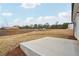This backyard features a small concrete patio, expansive land, and a view of nearby neighborhood at 2026 Avalon Rdg, Conyers, GA 30013