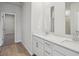 Bathroom showcasing double sinks and a large mirror and doorway to additional room at 2026 Avalon Rdg, Conyers, GA 30013