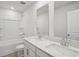 Bathroom featuring a double sink vanity, shower-tub combination with a clean, modern design at 2026 Avalon Rdg, Conyers, GA 30013