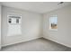 Bedroom featuring neutral walls and carpeting, with natural light streaming through the windows at 2026 Avalon Rdg, Conyers, GA 30013