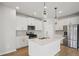 Bright kitchen with stainless steel appliances, white cabinets, and an island at 2026 Avalon Rdg, Conyers, GA 30013