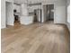 An open-concept living area showcasing the integration of the kitchen and living spaces with light wood flooring at 2026 Avalon Rdg, Conyers, GA 30013