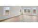 Bright living space featuring light hardwood floors, large windows, and a glass patio door leading to the outside at 2026 Avalon Rdg, Conyers, GA 30013