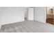 Spacious bedroom with neutral carpet, a view into the en suite bathroom, and a walk-in closet at 2028 Avalon Rdg, Conyers, GA 30013