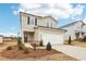 Traditional home with a two-car garage, tidy landscaping, and a welcoming front entrance at 2028 Avalon Rdg, Conyers, GA 30013