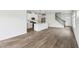 Open-concept living space with kitchen island, stainless steel appliances, and hardwood floors at 2028 Avalon Rdg, Conyers, GA 30013