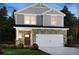 Two-story home with stone accents and a two-car garage at 2030 Avalon Rdg, Conyers, GA 30013