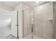 Bright bathroom with glass shower door, neutral color palette, and tiled shower at 2032 Avalon Rdg, Conyers, GA 30013