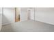 Open bedroom with neutral paint, plush carpet, and an entry into bathroom at 2032 Avalon Rdg, Conyers, GA 30013